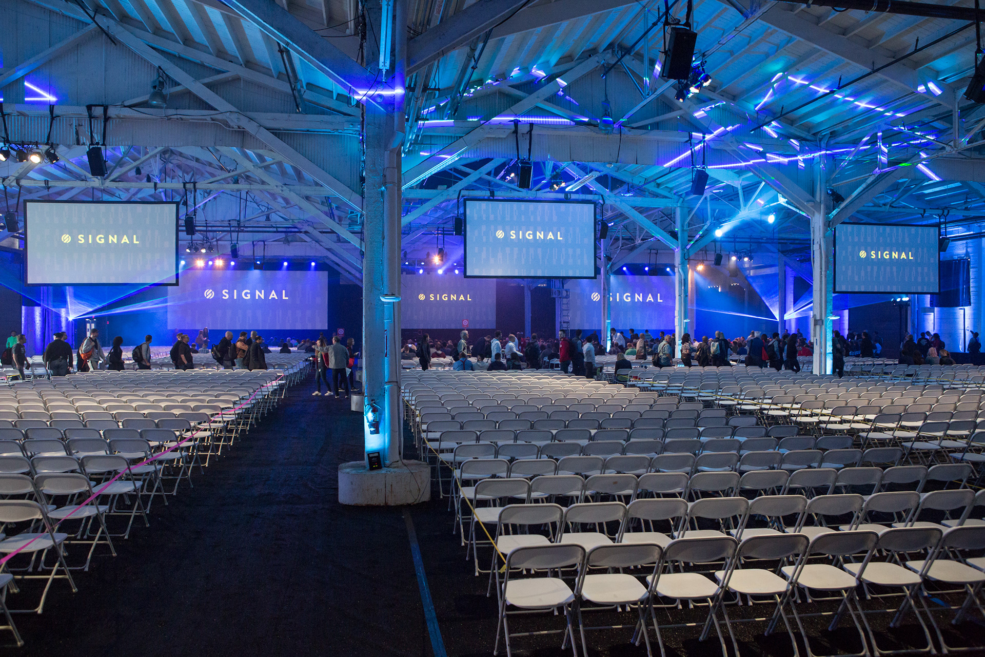 Twilio Signal venue setup with rows of empty chairs and Signal branding on screens